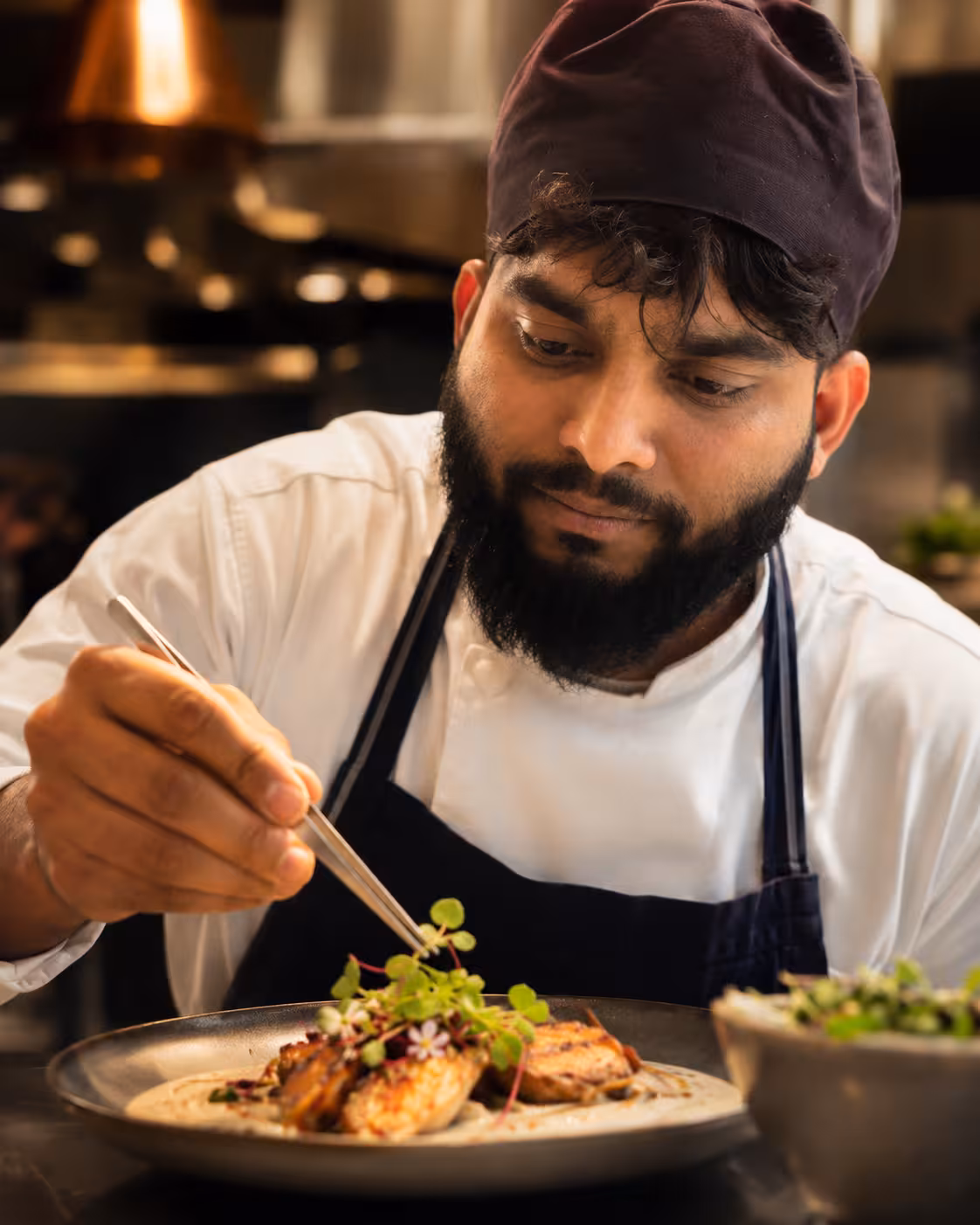 Chef preparing food at Xenia Restaurant Feltham